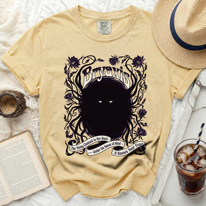 Yellow t-shirt with "Bryaxis" graphic and "The Thing Chained in the Dark" text.