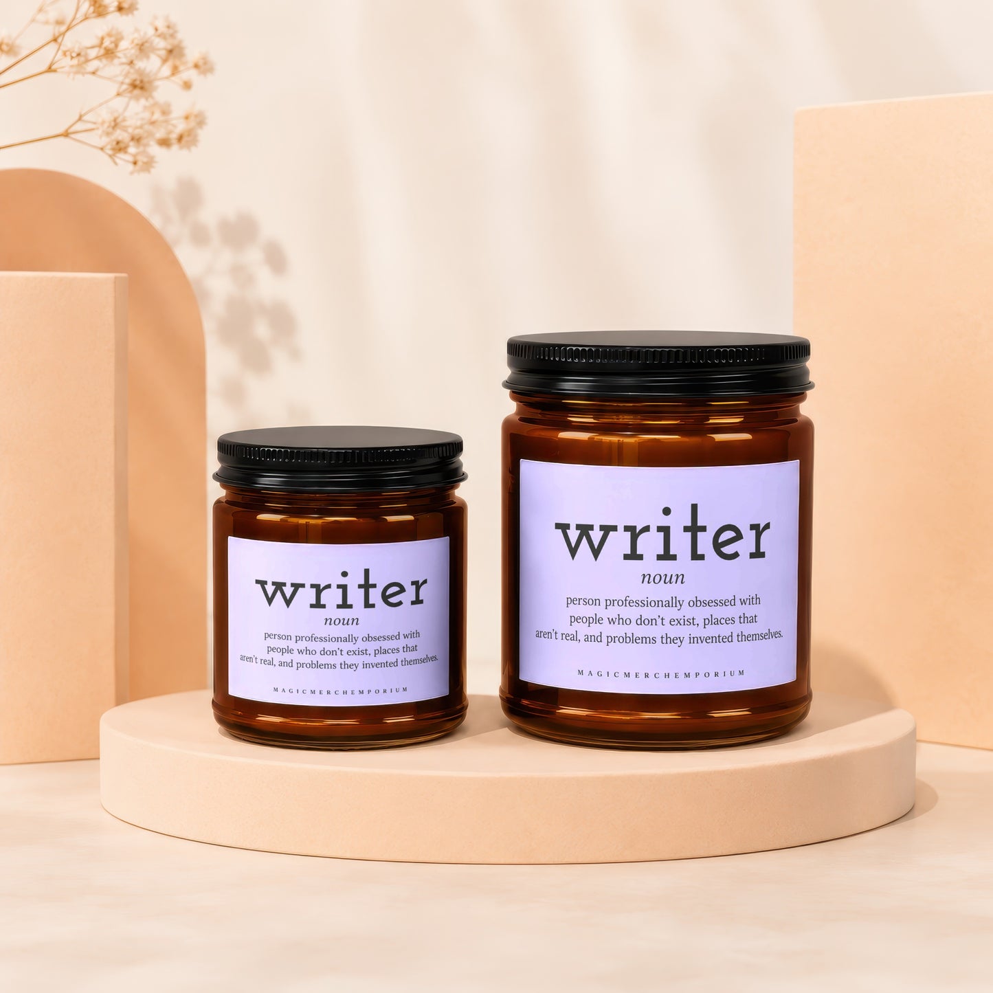 Two amber glass candles with black lids labeled "writer noun" with descriptive text.