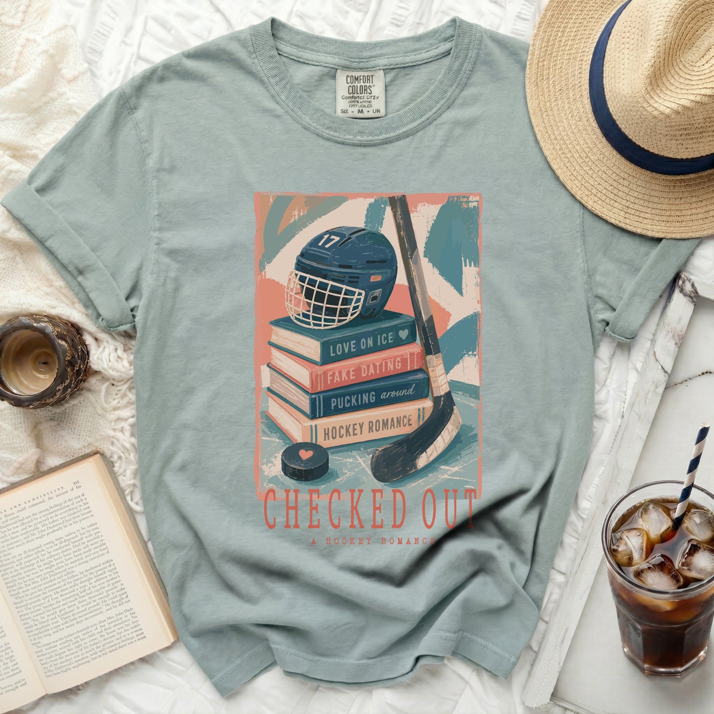 T-shirt with hockey romance book stack graphic and text "Checked Out".