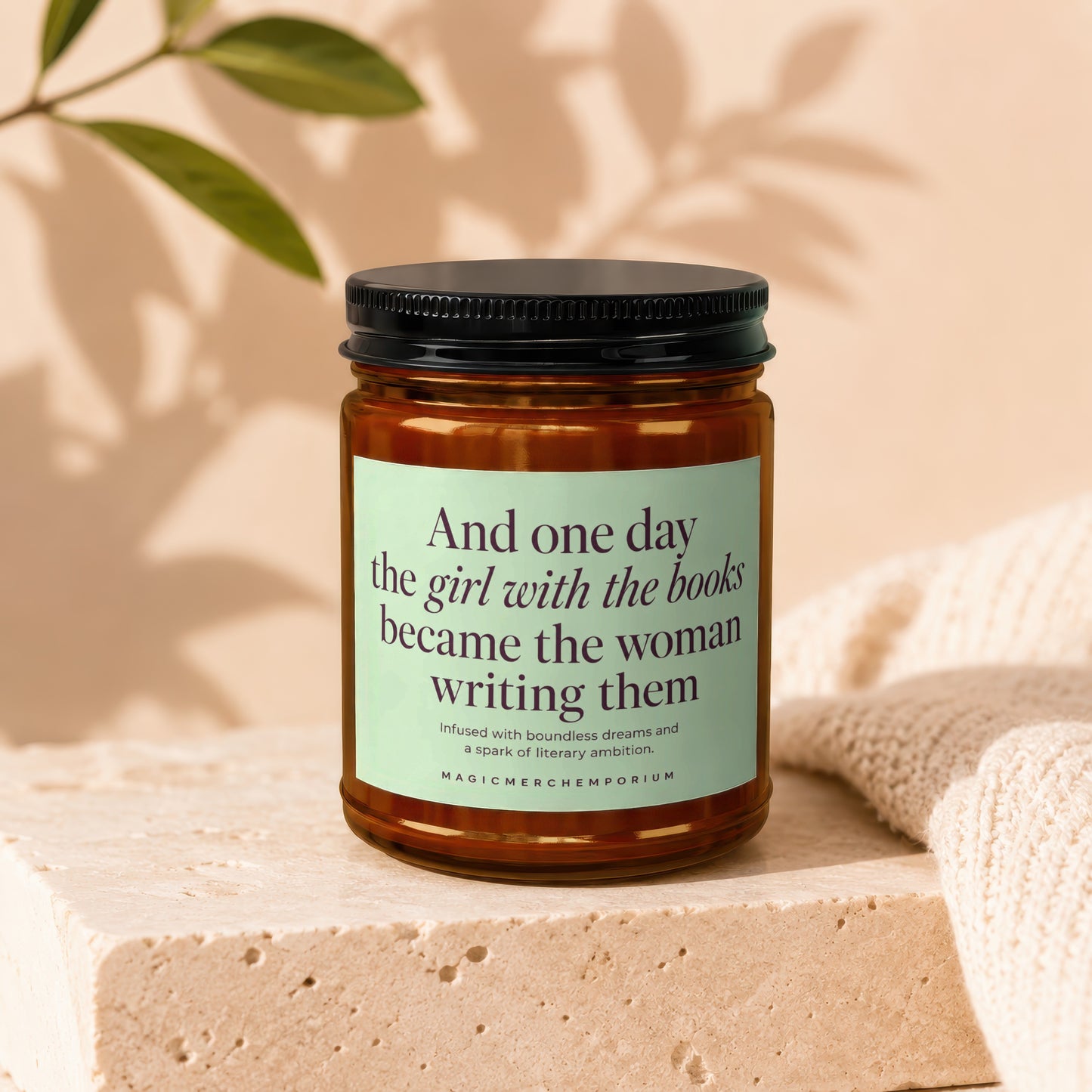 Candle with text "And one day the girl with the books became the woman writing them MAGICMERCHEMPORIUM".
