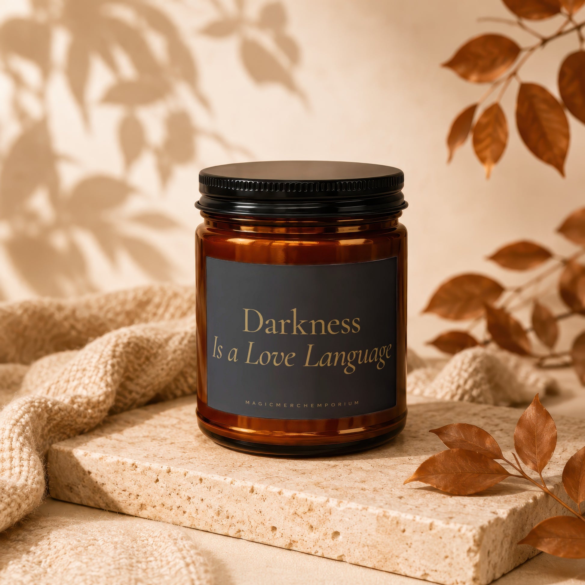 Amber jar candle with black lid reading "Darkness Is a Love Language".