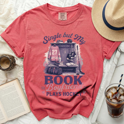 Red t-shirt with "Single but My Boyfriend Plays Hockey" text and hockey gear graphic.