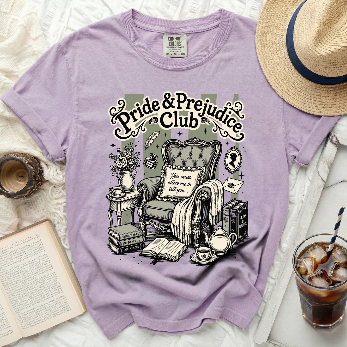 Purple t-shirt with "Pride & Prejudice Club" print and vintage reading scene.