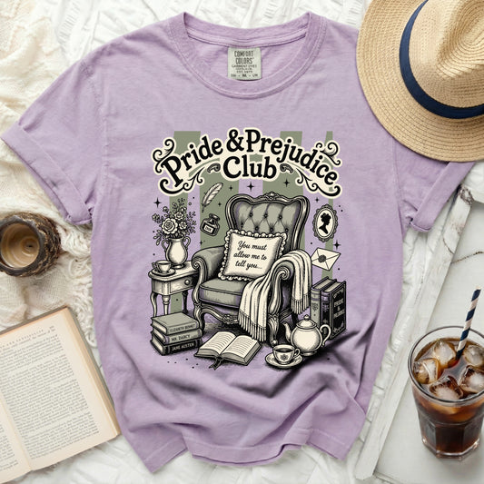 Purple t-shirt with "Pride & Prejudice Club" print and vintage reading scene.