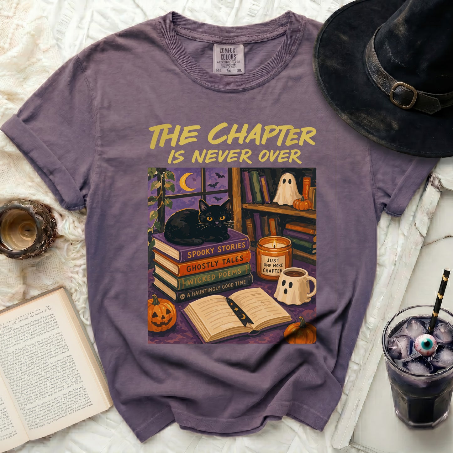 Purple t-shirt with a Halloween graphic featuring a black cat and books.