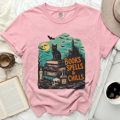 Black cat on books with Halloween castle, bats, and "Books Spells & Chills" text.