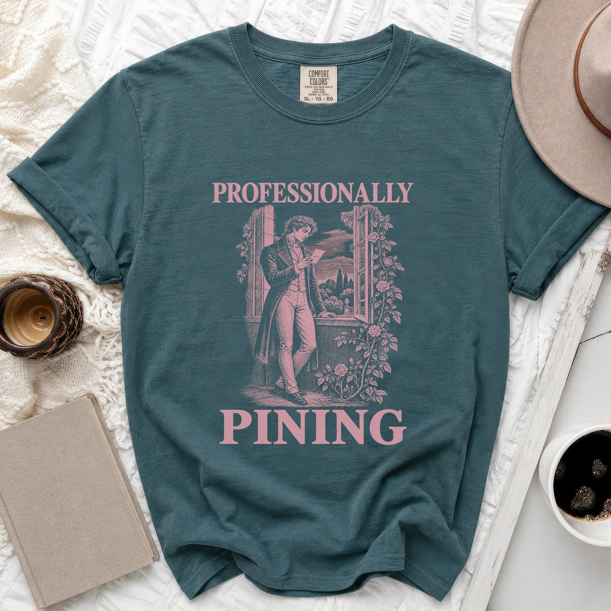 Teal t-shirt with "PROFESSIONALLY PINING" text and vintage illustration.