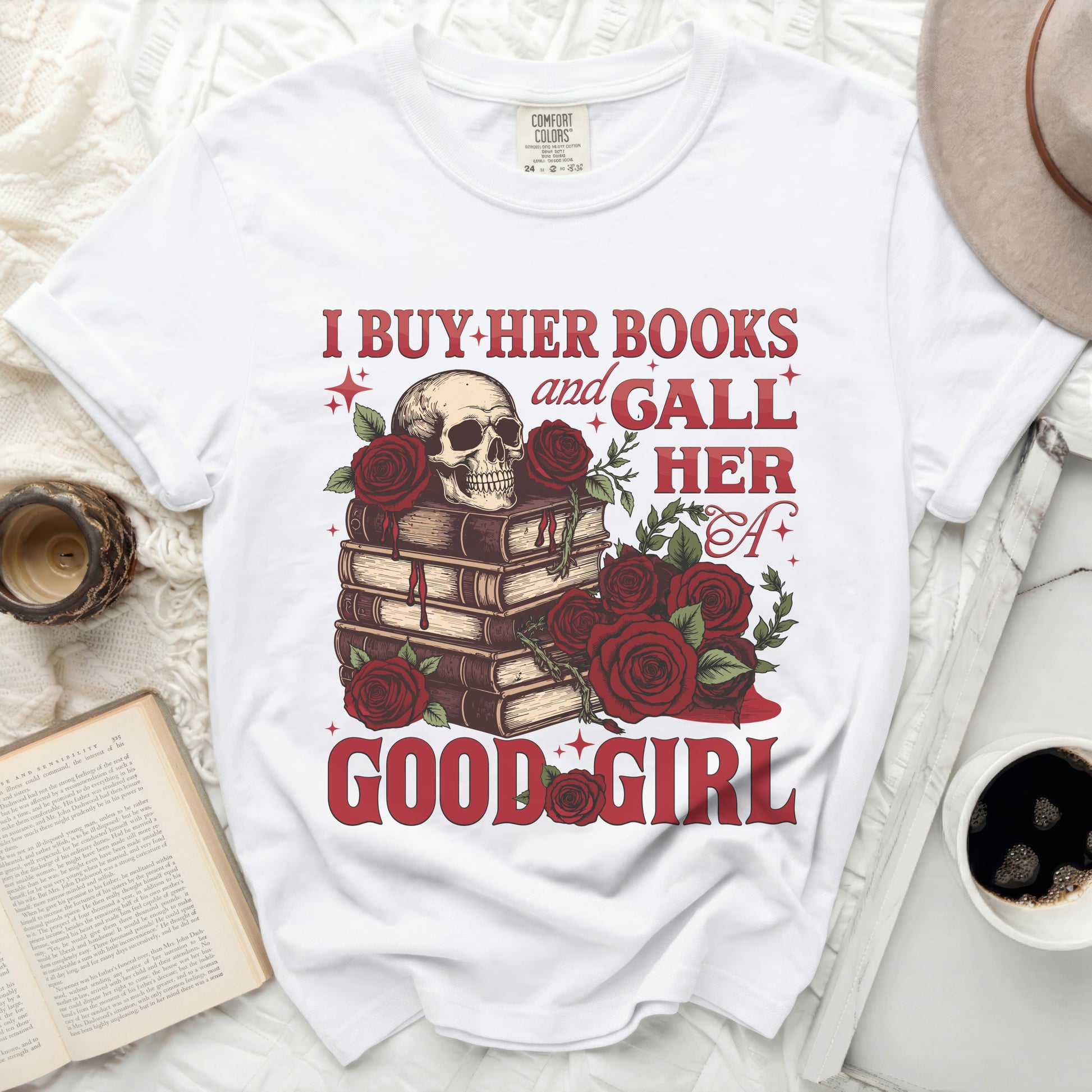 White comfort colors t-shirt with skull, books, and roses graphic and text.