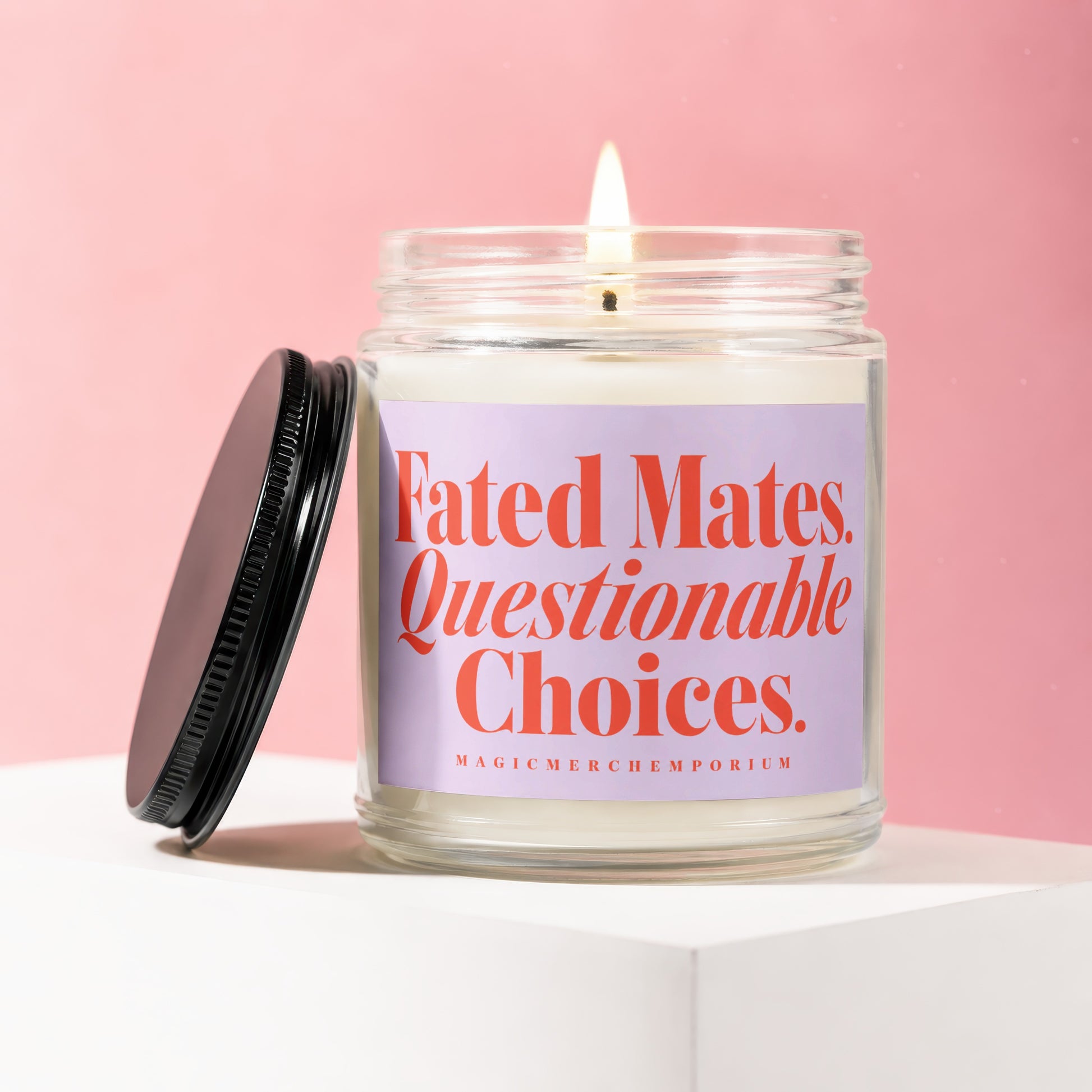 Glass jar candle with a lit wick and label reading "Fated Mates. Questionable Choices."