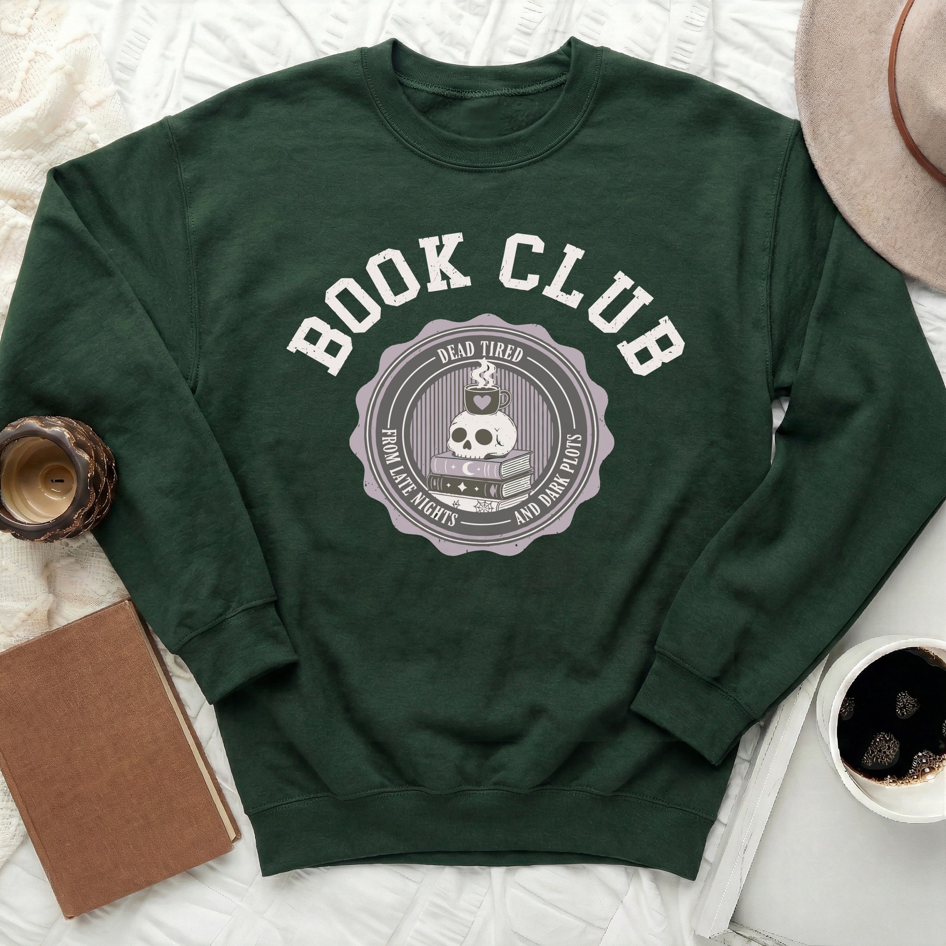 Green sweatshirt with "Book Club" text and a skull with books and coffee cup graphic.