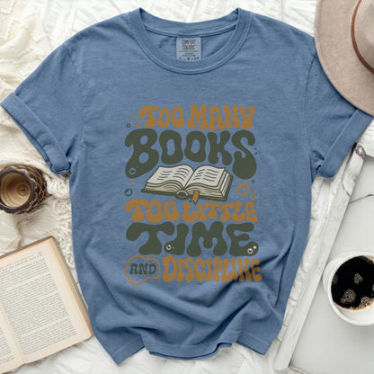 Blue t-shirt with "Too Many Books, Too Little Time, And Discipline" text.
