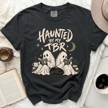 Dark gray t-shirt with "HAUNTED BY MY TBR" text and ghost reading.