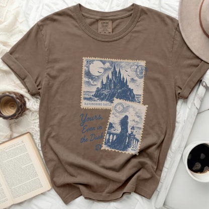 Brown t-shirt with "Ravenshore Castle" and "Yours, Even in the Dark" text.