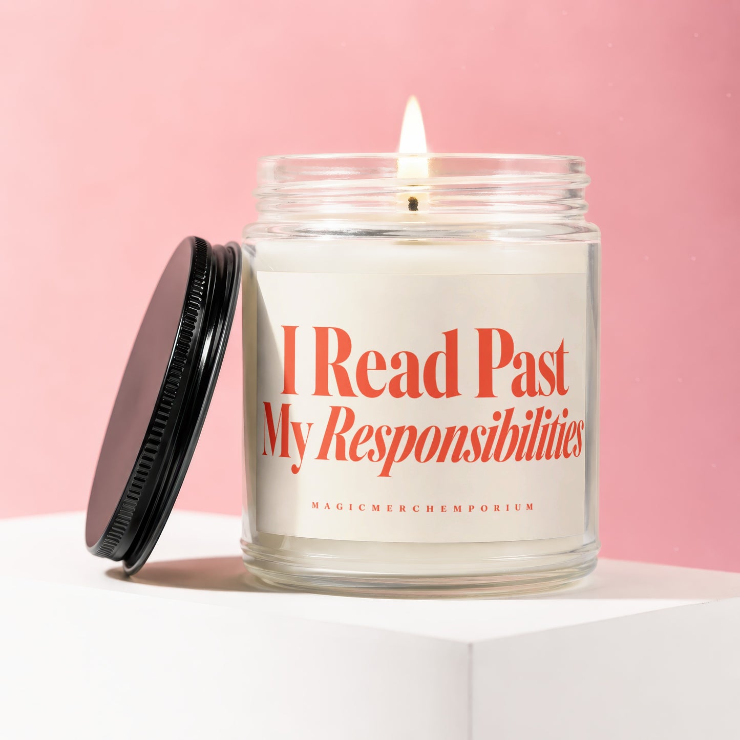 Lit glass candle with orange text that says "I Read Past My Responsibilities."
