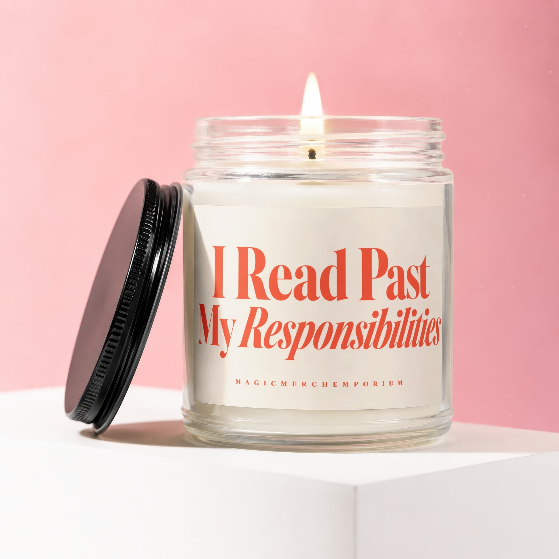 Lit glass candle with orange text that says "I Read Past My Responsibilities."