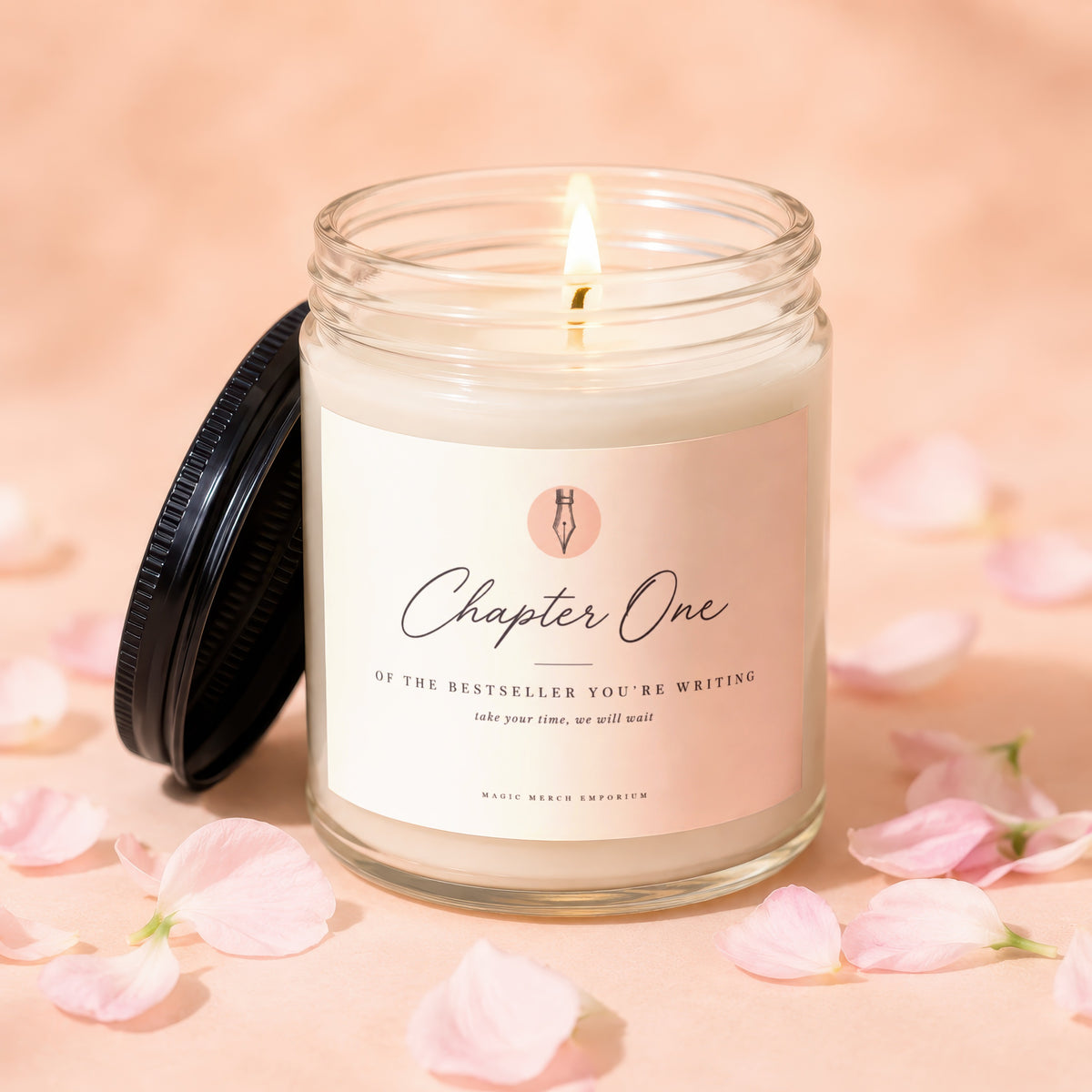 Lit candle in glass jar with "Chapter One" label, surrounded by pink petals.