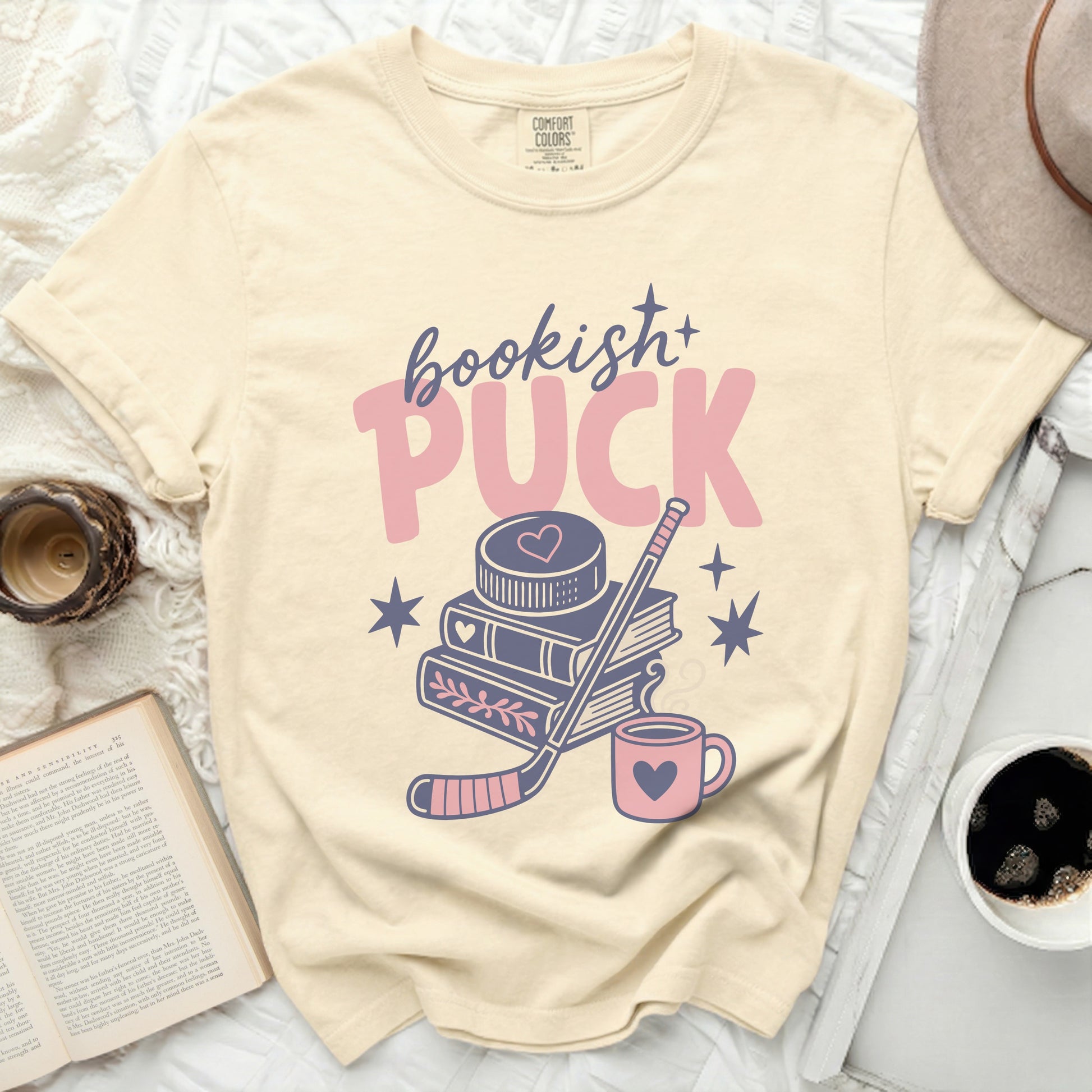 Cream t-shirt with "bookish+ PUCK" and hockey graphics.