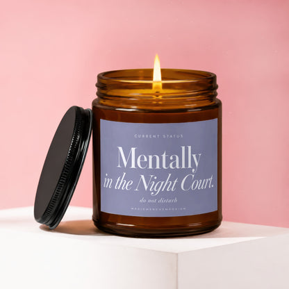 Lit amber glass candle with lid ajar, labeled "Mentally in the Night Court. do not disturb."