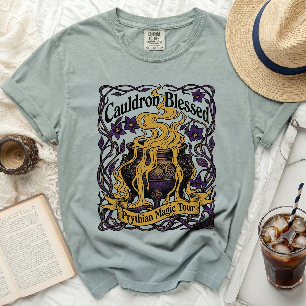 Light green t-shirt with "Cauldron Blessed Prythian Magic Tour" graphic.