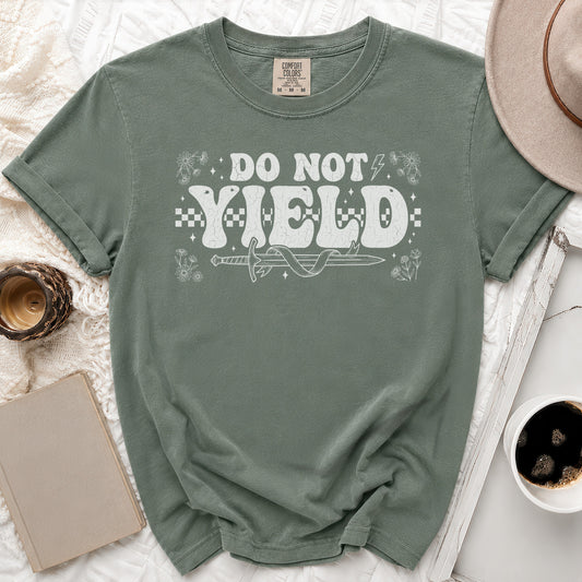 Sage green t-shirt with "DO NOT YIELD" text, sword, and flowers design.