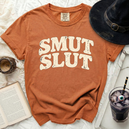 Orange t-shirt with "SMUT SLUT" text in distressed cream font.