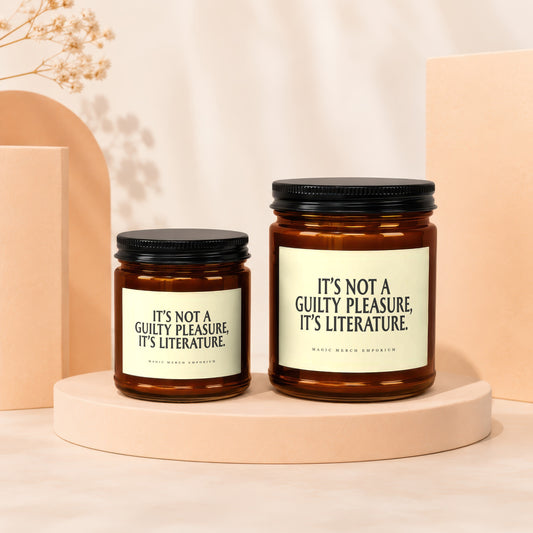 Two amber glass candles with black lids and cream labels reading "It's not a guilty pleasure, it's literature."