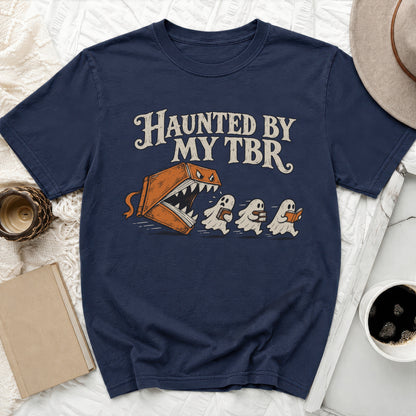 Navy t-shirt with "Haunted by My TBR" text and cartoon book chasing ghosts.