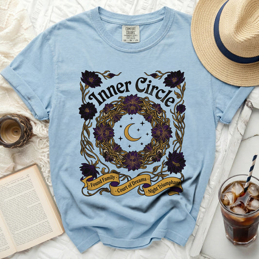 Light blue t-shirt with "Inner Circle" text and floral wreath graphic.