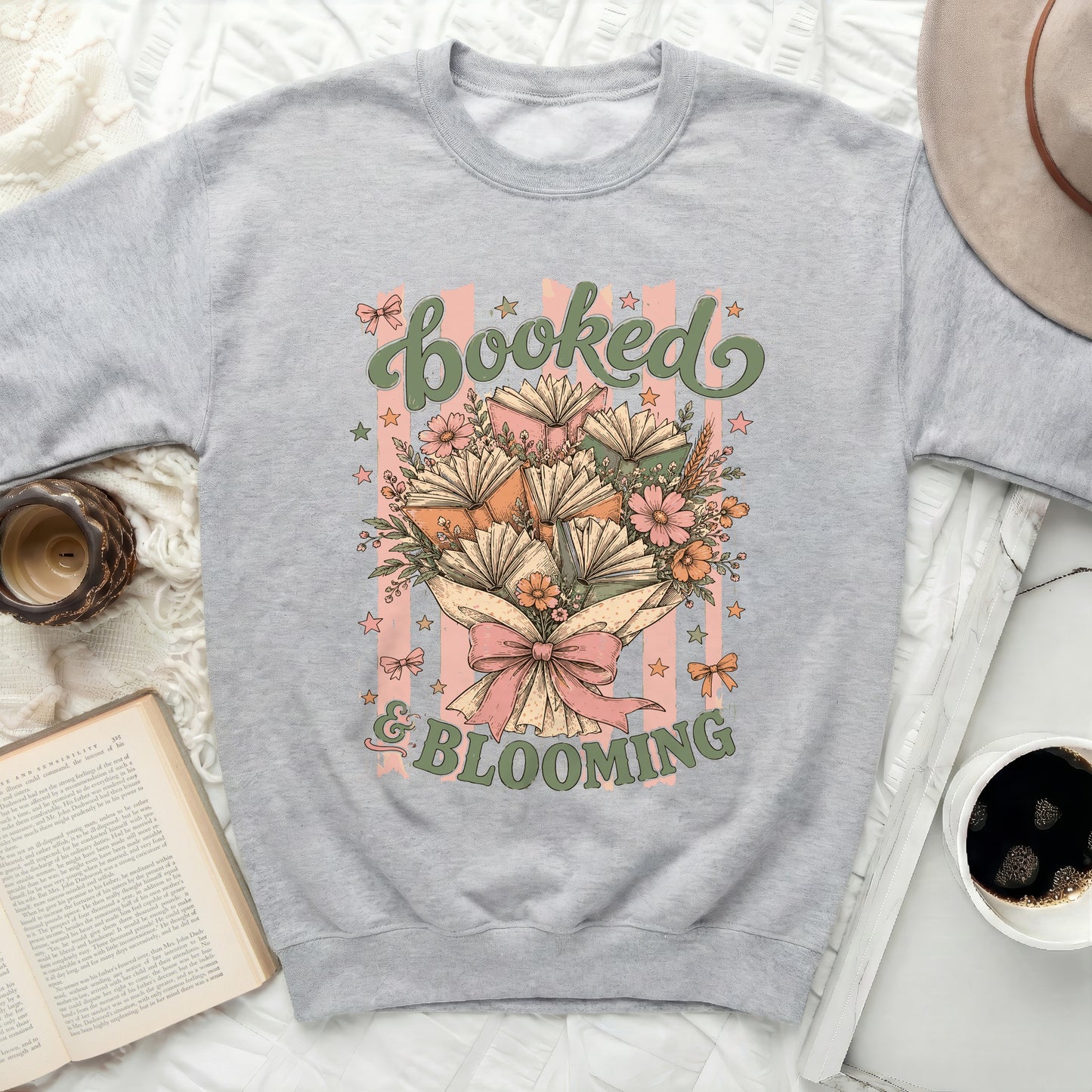 Sweatshirt with "Booked & Blooming" text and floral book graphic.
