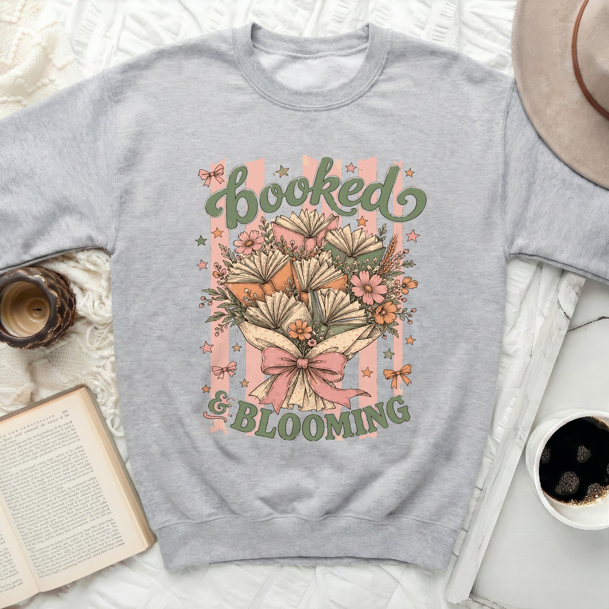 Sweatshirt with "Booked & Blooming" text and floral book graphic.
