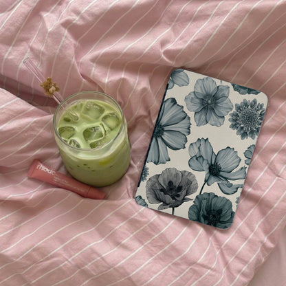 Phone case with floral pattern beside drink and lip balm on pink striped fabric.