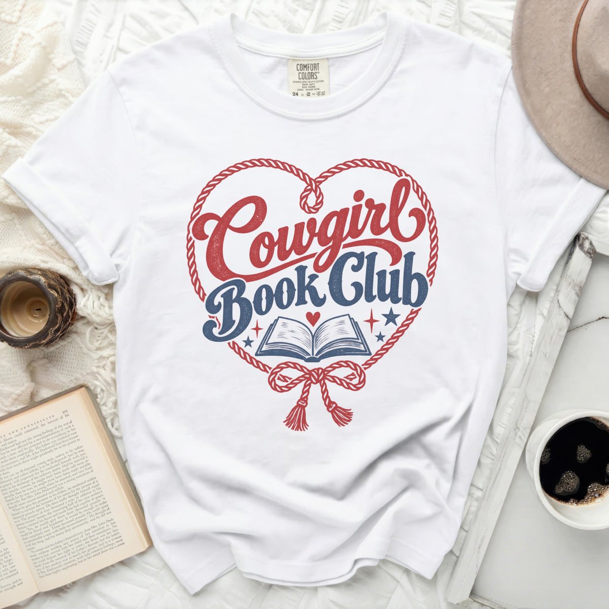 White t-shirt with "Cowgirl Book Club" graphic in a heart shape.