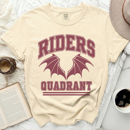 Cream t-shirt with maroon "RIDERS QUADRANT" graphic and dragon wings.