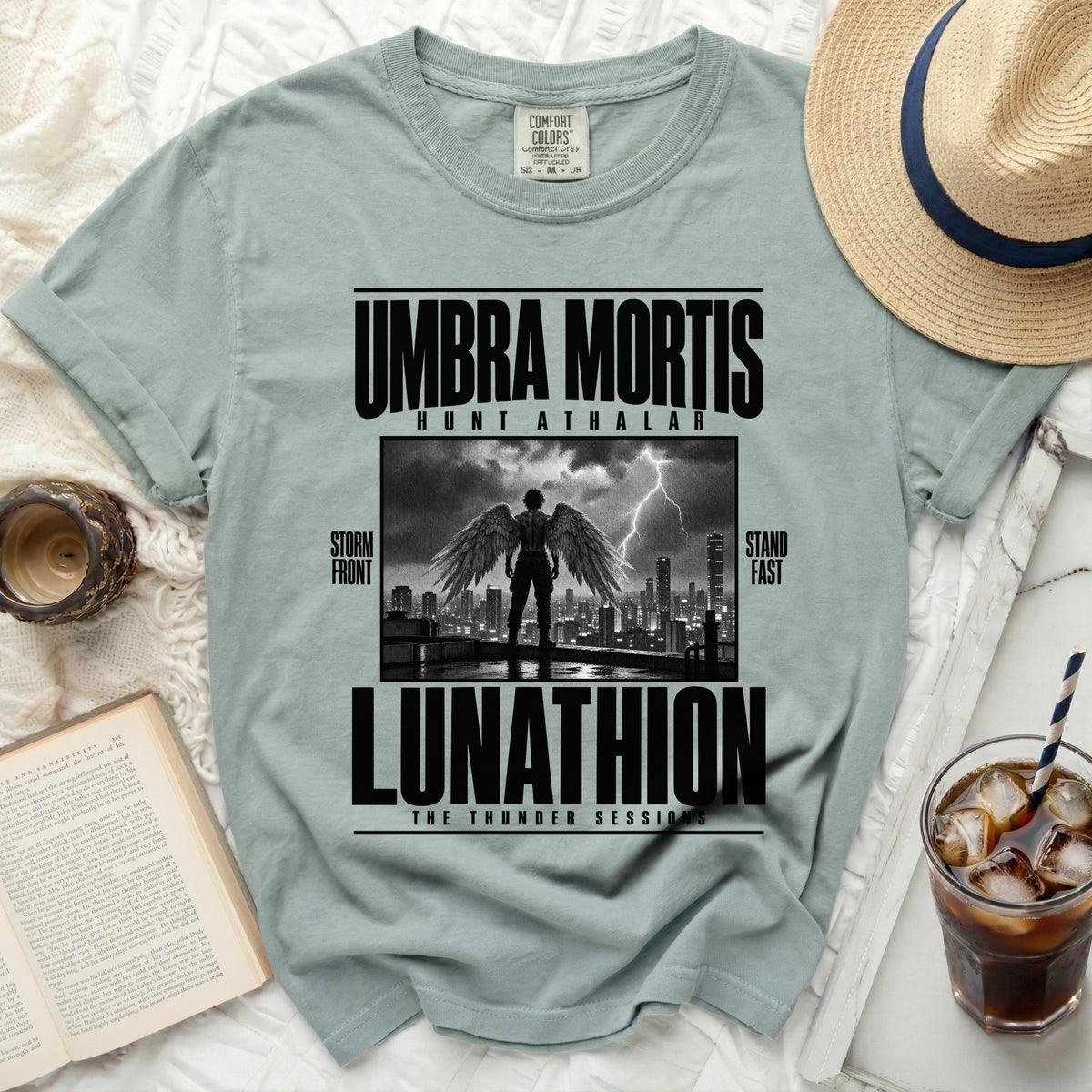 Comfort Colors t-shirt with "Umbra Mortis Lunathion" graphic featuring winged figure over cityscape.