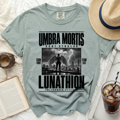 Comfort Colors t-shirt with "Umbra Mortis Lunathion" graphic featuring winged figure over cityscape.
