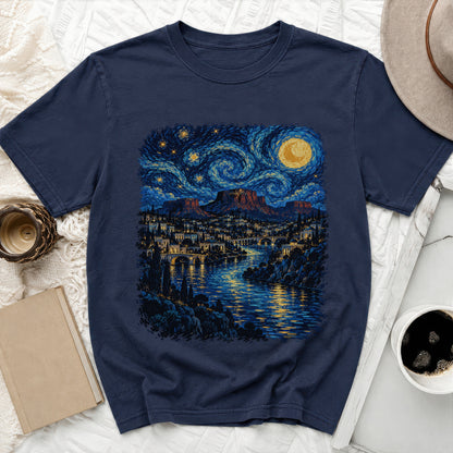 Navy t-shirt with a starry night landscape and cityscape printed on it.