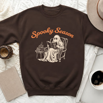 Brown sweatshirt with vintage ghost reading "Dead Tired But Well Read" graphic.