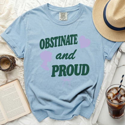 Light blue t-shirt with "OBSTINATE and PROUD" text graphic.