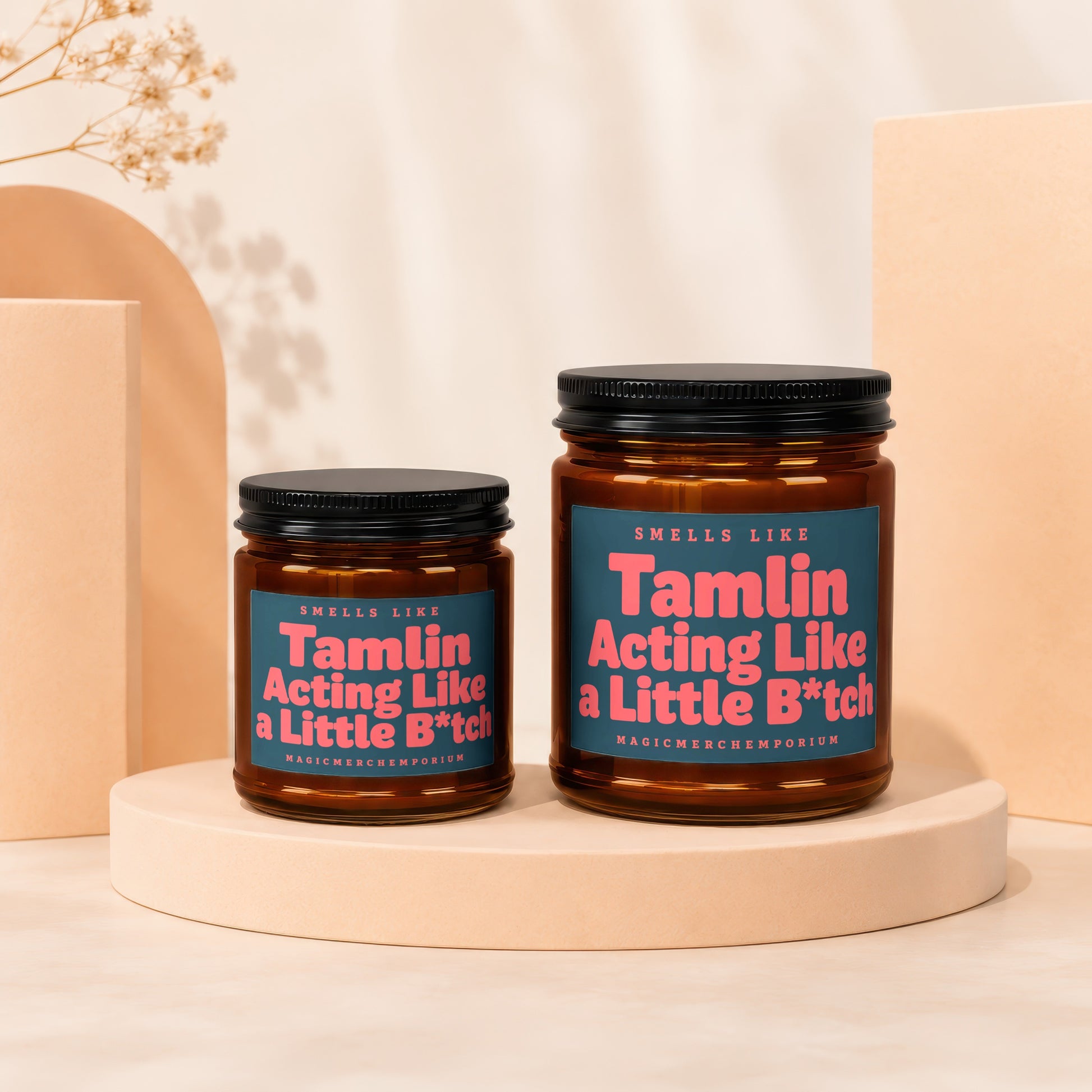 Two amber glass candles with black lids, labeled "Tamlin Acting Like a Little B*tch".