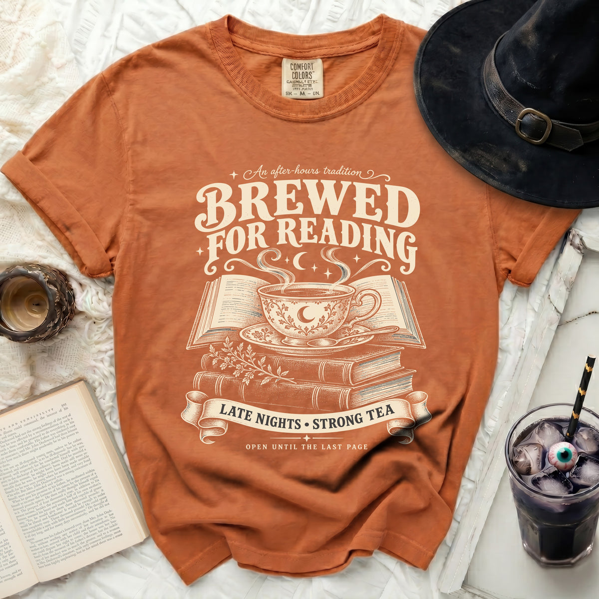 Orange t-shirt with "Brewed For Reading" text, tea cup, books, and witch hat.