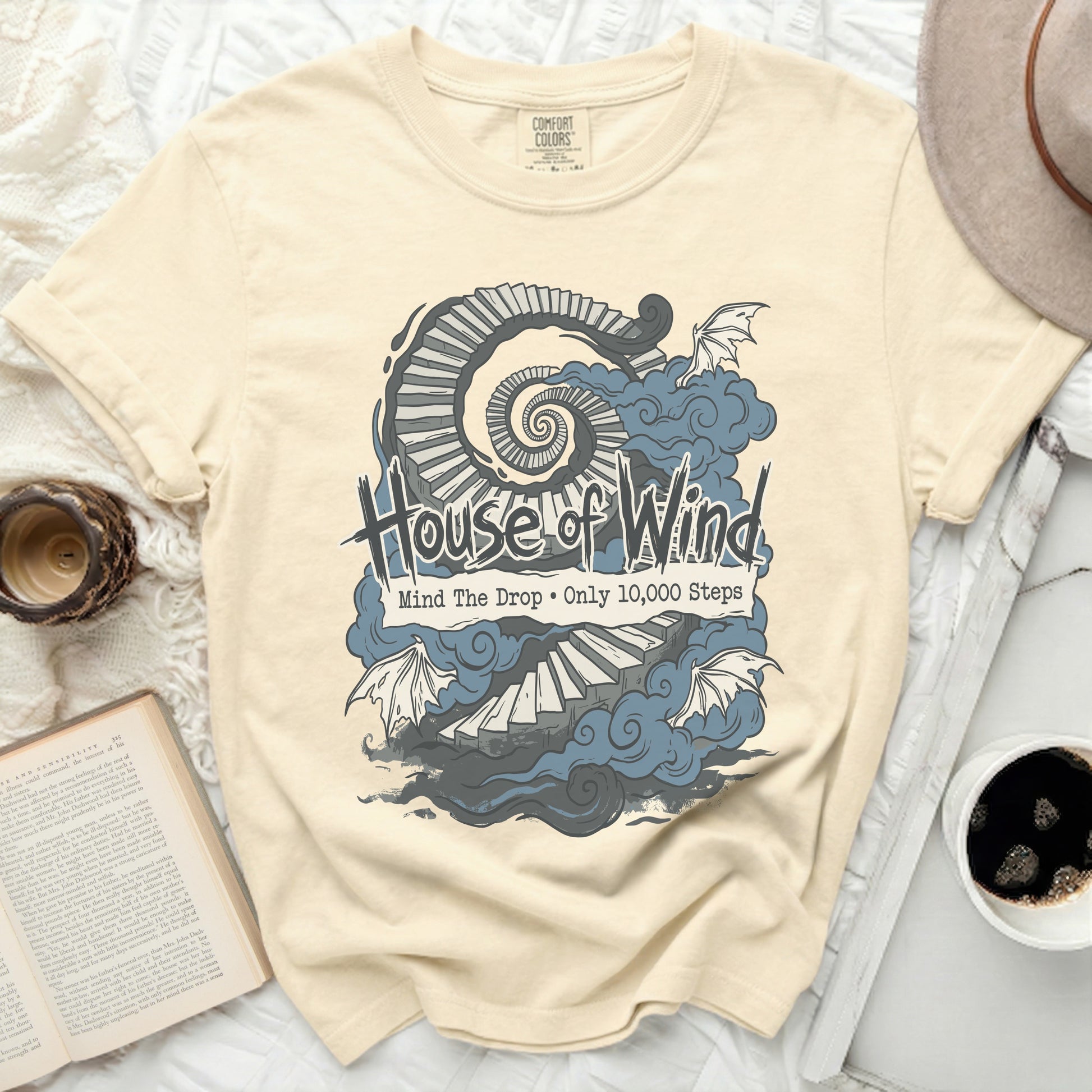 House of Wind t-shirt with spiral stairs, clouds, and dragon wings.