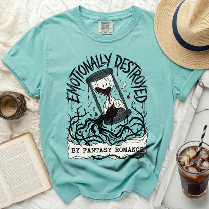 Broken hourglass with dripping blood surrounded by thorns, text "Emotionally Destroyed by Fantasy Romance".