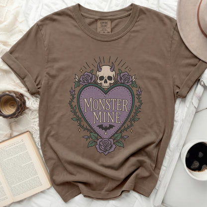 Brown t-shirt with "Monster Mine" heart graphic and purple roses.