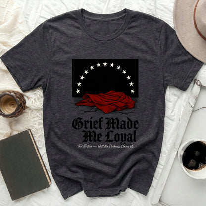 Dark t-shirt with white text and a graphic of a draped red cloth and stars.