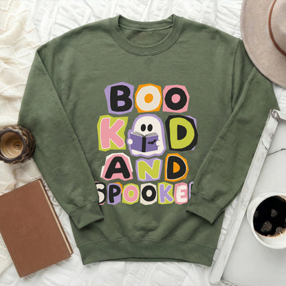 Green crewneck sweatshirt with "Boo, Kook, and Spooked" text and ghost graphic.