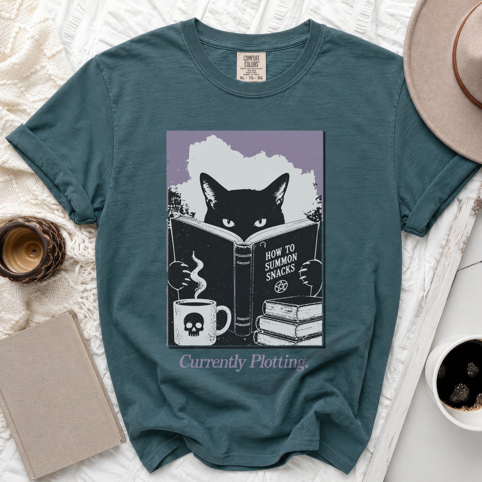 Teal t-shirt with black cat reading "How to Summon Snacks".