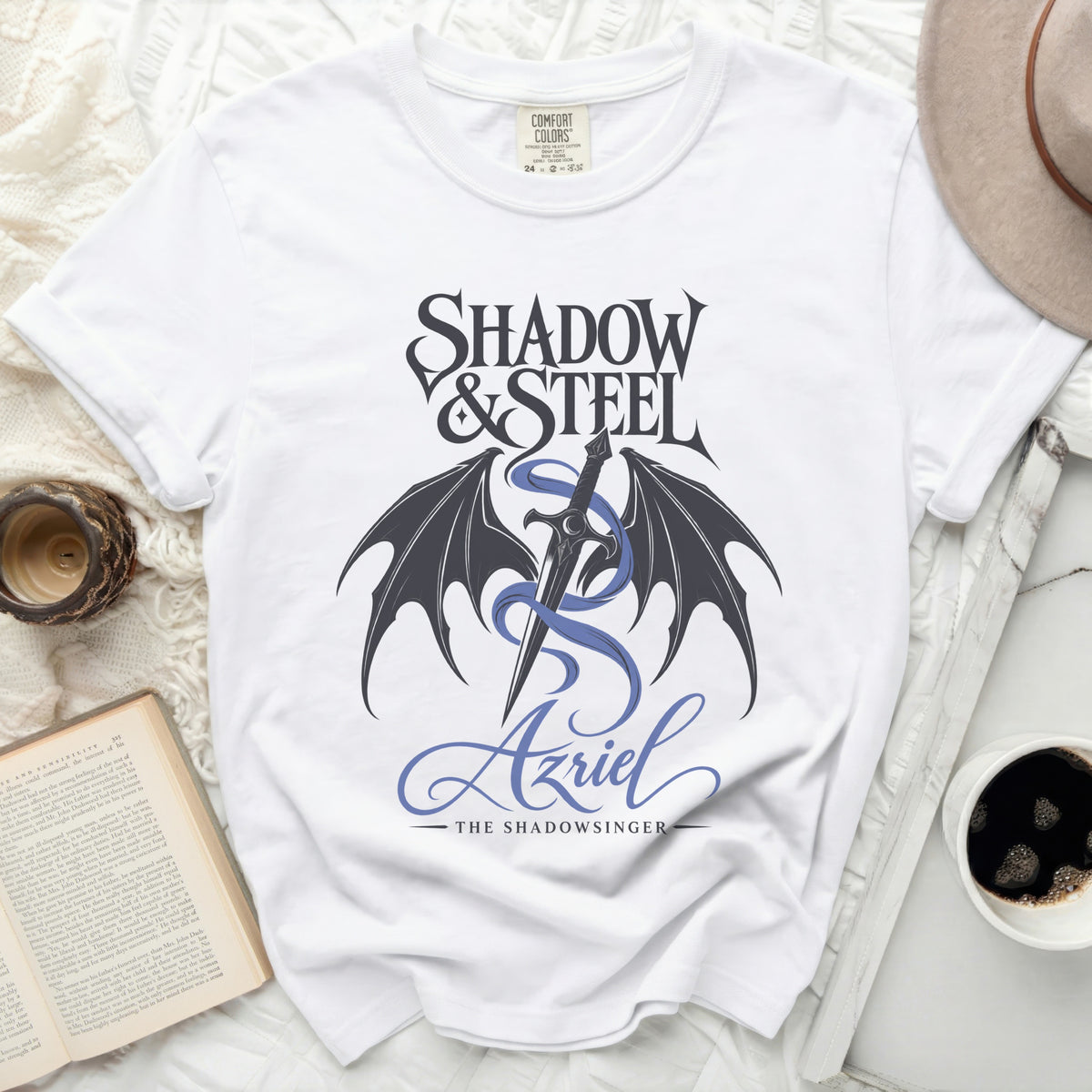 White t-shirt with "Shadow & Steel Azriel The Shadowsinger" text and graphic.