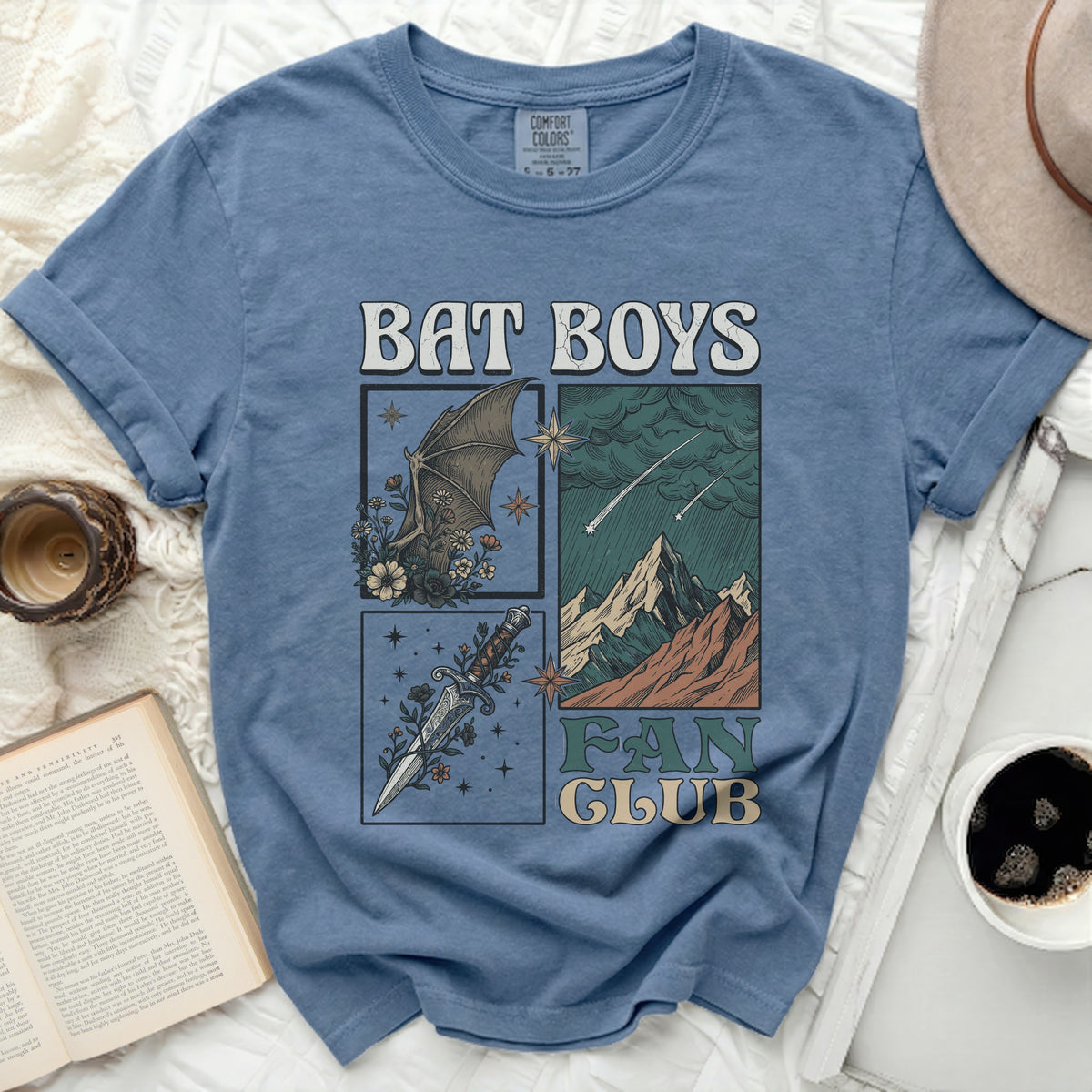 Blue t-shirt with "BAT BOYS FAN CLUB" text and graphics of a bat, mountains, and dagger.