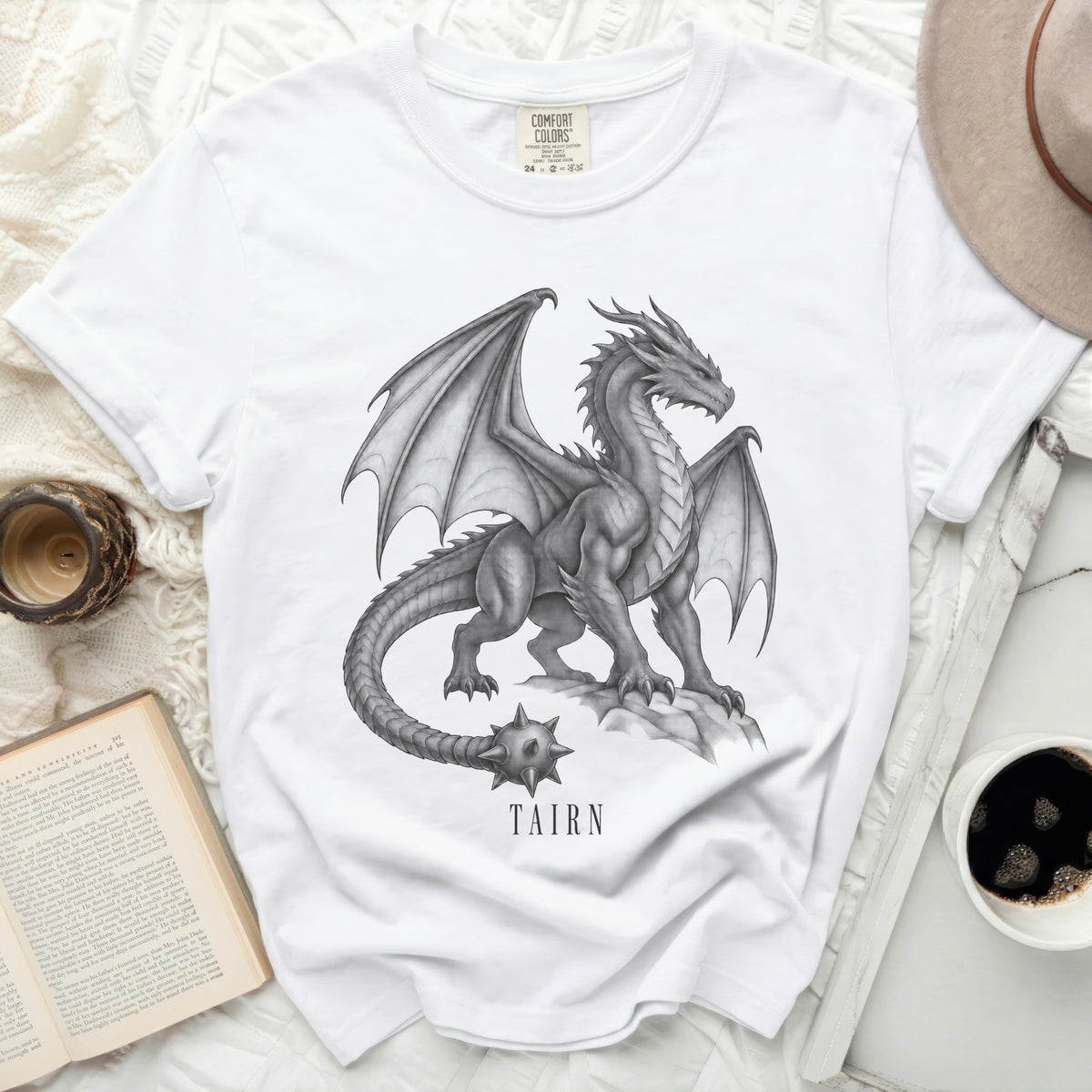 White t-shirt with a detailed dragon graphic and "TAIRN" text.