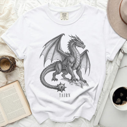 White t-shirt with a detailed dragon graphic and "TAIRN" text.